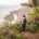 Female Digital Nomad spreading her arms at a stunning ocean view on Madeira island