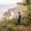 Female Digital Nomad spreading her arms at a stunning ocean view on Madeira island